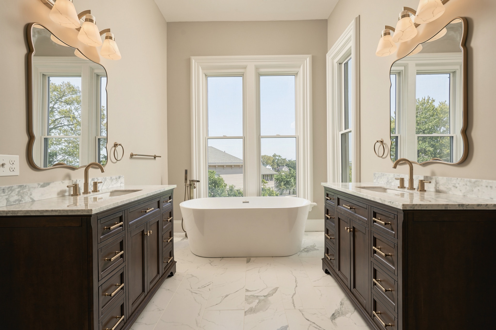 Primary bath with twin vanities and a freestanding tub